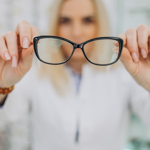 Female optician working at optic store